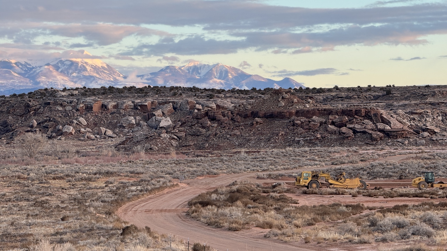 Motor scraper working an earthwork site in the western U.S. with the La Sal mountain range in the background